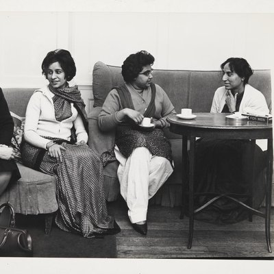 Photo of four individuals sat down on sofas