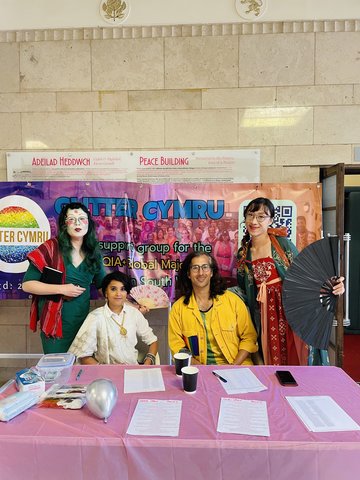 Image taken at Glitter Pride 2024, Jien Teh, Shana Parvin, Numair Masud and Mica Soft seated at table.