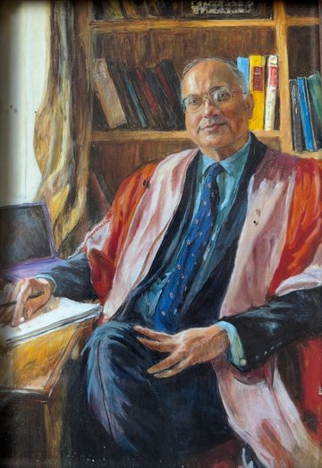 Painting of Haroon Ahmed seated at table in gown.