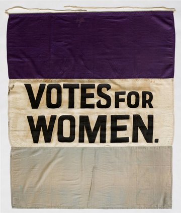 Suffragette banner, saying 'Votes for Women' in capital letters